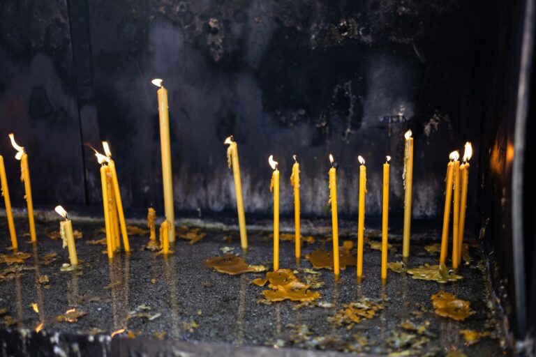 Lit prayer candles in a church shrine