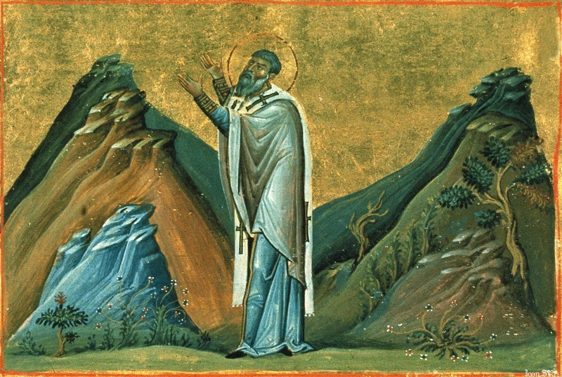Byzantine miniature: St. Abercius standing in prayer between rocky hills.