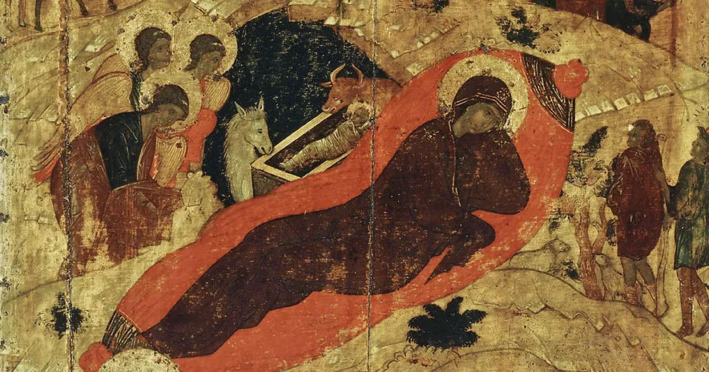 Detail of a historic Nativity icon, with the infant Christ in the manger, the reclining Theotokos and adoring angels.